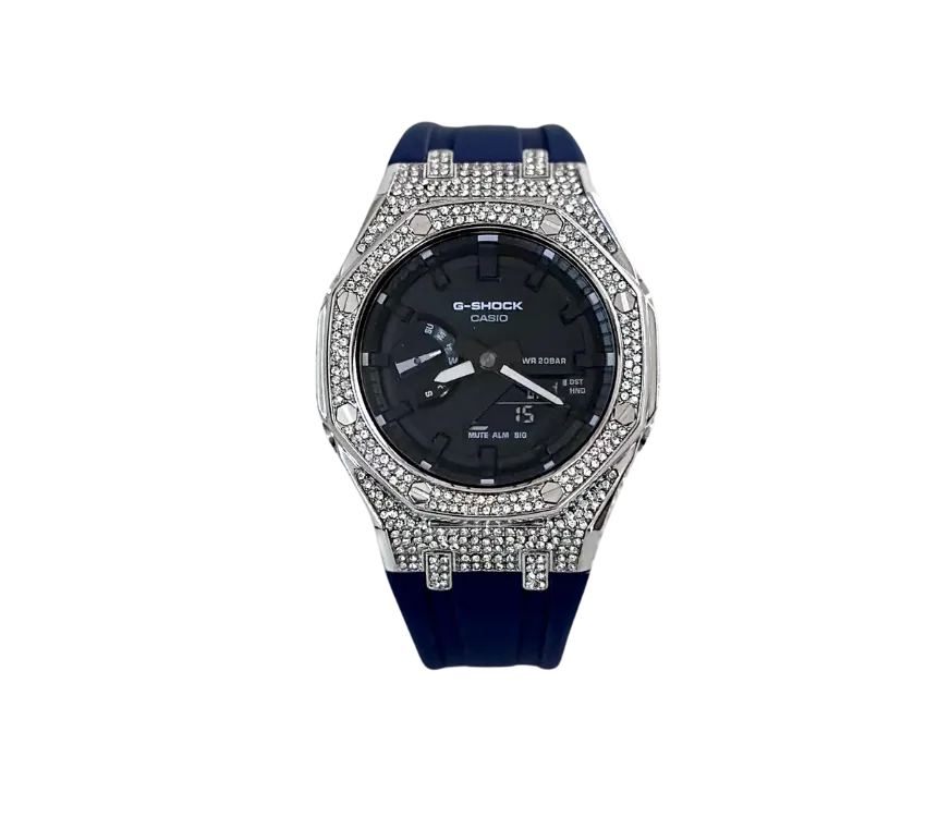 Montre Casio G-Shock élégante avec boîtier serti de cristaux scintillants, cadran noir fonctionnel et bracelet en silicone bleu foncé pour une allure moderne et robuste.