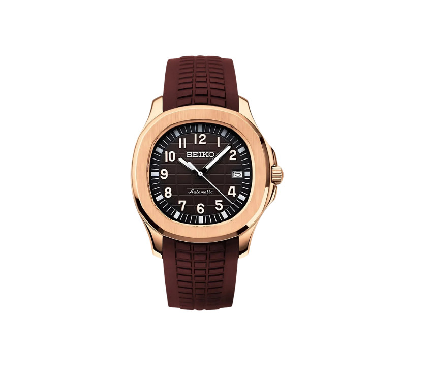 Montre Seiko avec boîtier plaqué or rose, cadran marron texturé avec chiffres blancs, guichet de date à 3 heures, et bracelet en silicone marron assorti.